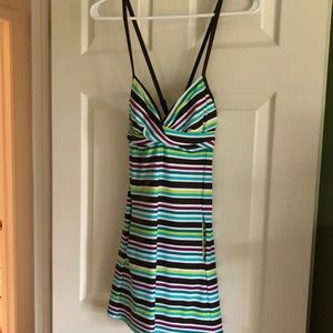 One piece bathing suit, dress style with attached bottoms, pockets on each side